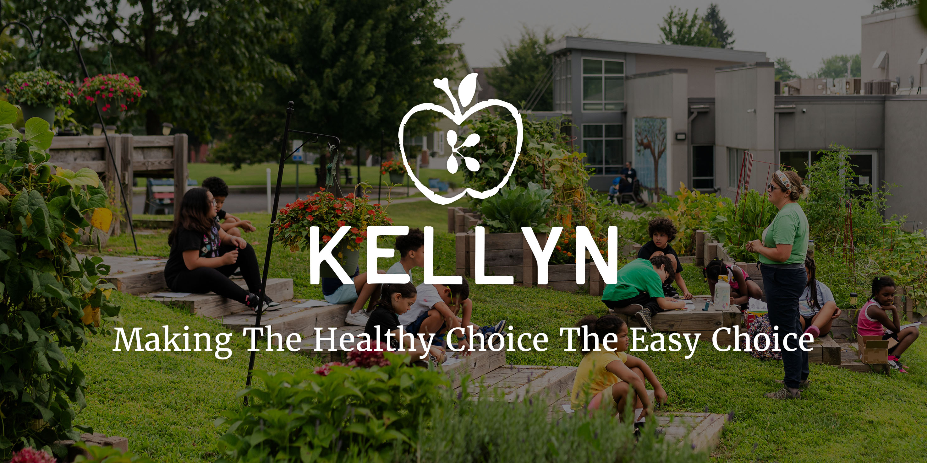 Kellyn logo - a green apple with four different colored seeds in the shape of k in the middle