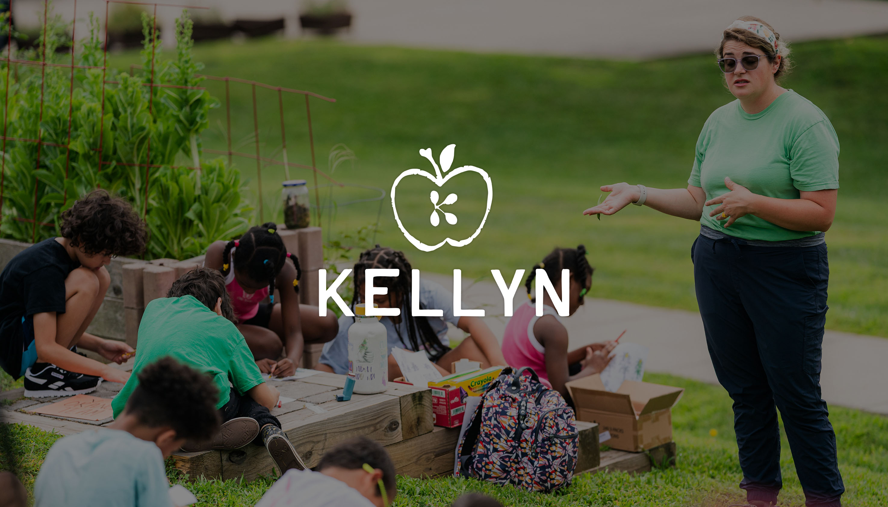a kellyn volunteer talking to children outside during a kellyn program